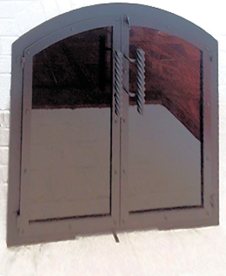 Nantucket Arch All black finish, twin doors with heavy twist textured handles, smoked glass with hidden draft panel. Comes with gate mesh spark screens.